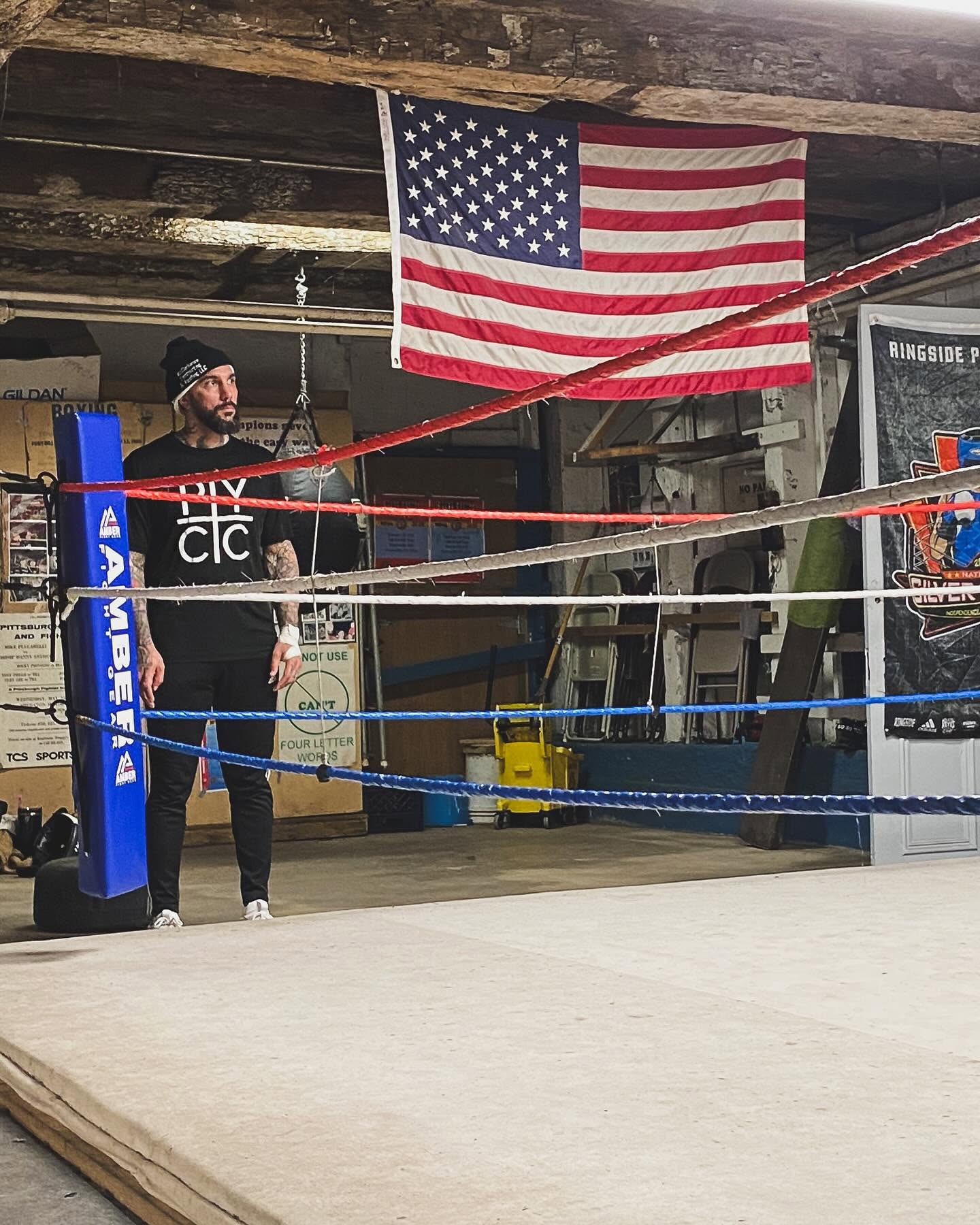 Coach in the ring under the flag